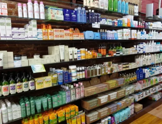 A store shelf densely stocked with assorted personal care products—shampoos, conditioners, and lotions in bottles and boxes.